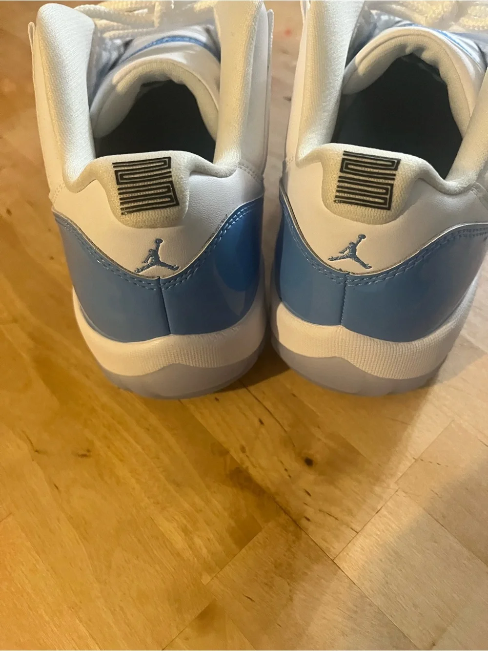 UNC Jordan 11 Low-Top Sneakers in White and Light Blue Patent